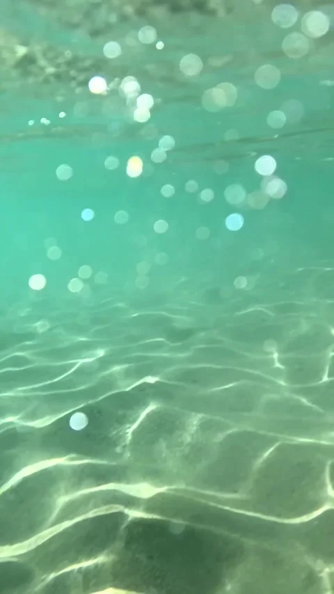 Air bubbles rise gracefully to the surface. Underwater video 動画素材 303210214