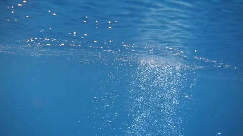 Air bubbles rise to the surface of the blue sea Stock Footage 294950629