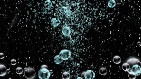Air bubbles rising through clear water against a solid black background Stock Footage 346213656