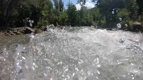Air bubbles under mountain river water Stock Footage 136842838