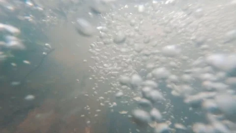 Air bubbles under water in a rushing stream 動画素材 107330937