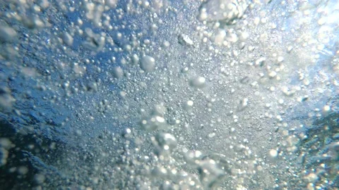 Air bubbles under water. Sunlight and oxygen bubbles in the sea underwater Stock Footage 136076503
