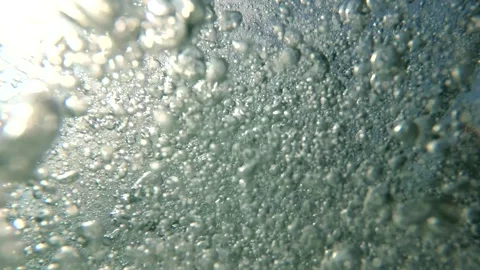 Air bubbles underwater rise to the surface of the sea Stock Footage 296488584
