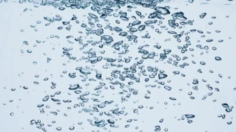 Air bubbles in water. Slow motion shot of bubbles in mineral water over white Stock Footage 237616052