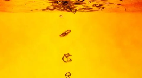 Air bubbles on a yellow background . Stock Photos