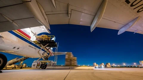 Air cargo freighter with import and export at twilight sky - Time lapse Видео 100769477