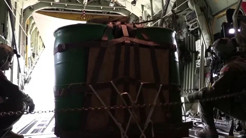 Air Commandos launch cargo on parachute from rear of Hercules C-130 Stock Footage 83978066