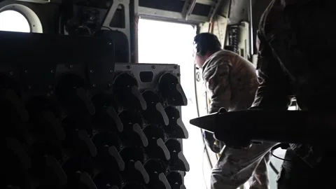 Air Commandos loading rounds into storage racks on AC-130J Ghostrider Gunship Video stock 258336141