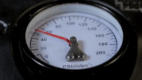Air compressor gauge close up losing PSI pressure. Workshop equipment used for a Stock Footage 120577543