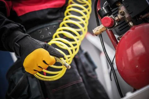 Air Compressor in a Hand. Professional Auto Service Equipment. Fotos Stock