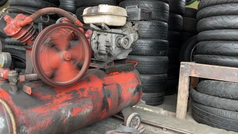 Air compressor used in a auto shop for inflating tire. Stock Footage 243638791