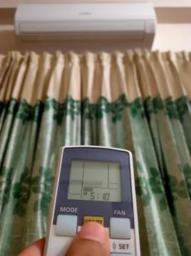 Air condition control by using remote control. Selective focus Stock Photos