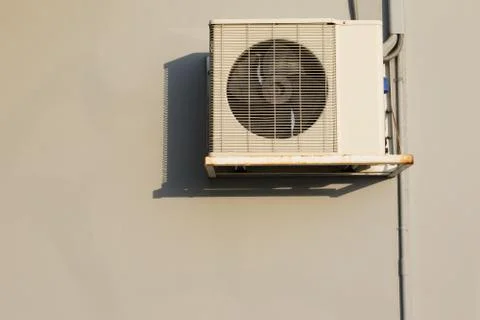 Air condition heating coil handing on building wall with beautiful light and  Fotos de archivo