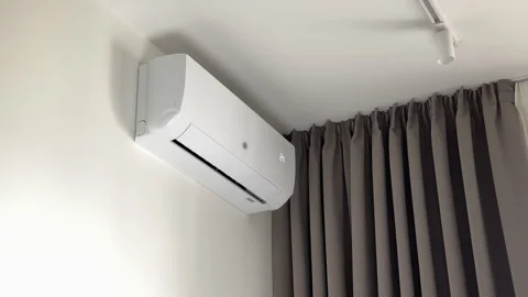 Air conditioner activated by a remote control to set temperature to 24 degr.. Stock-Footage 346155948