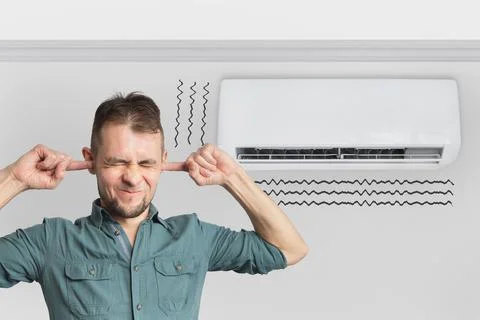 The air conditioner is broken - makes loud noises, noises and vibrations. Man Stock Photos