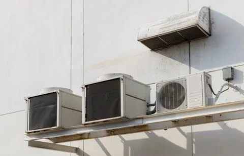 Air conditioner compressor installed in old building. Stock Photos