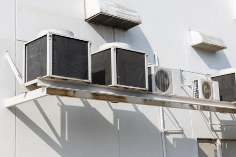 Air conditioner compressor installed in old building. 스톡 사진
