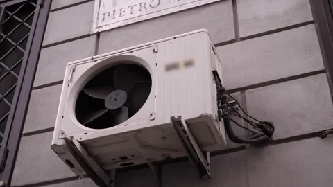 Air Conditioner Engine Running with Broken Grill on Roman Wall Exterior Stock Footage 320257108