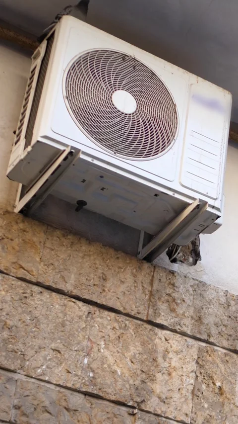 Air Conditioner Engine Running with Broken Grill on Roman Wall Exterior 動画素材 334775016