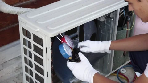 The air conditioner master checks and refills the air conditioner with freon Stock Footage 140564494