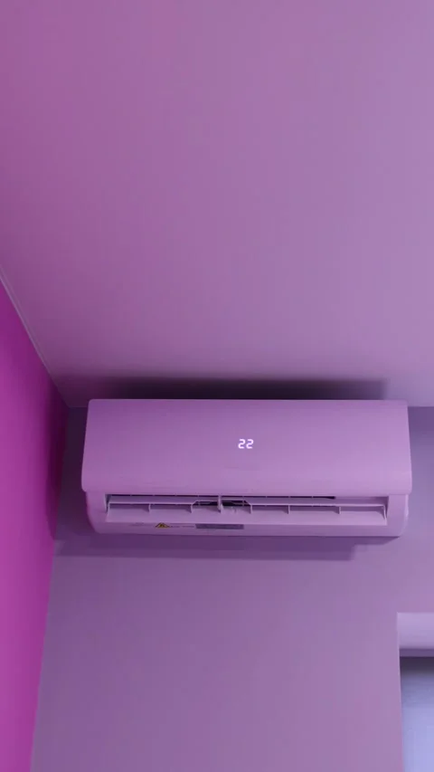 Air conditioner on pink wall cooling room close up. Vertical lifestyle vide.. Stock Footage 337346770