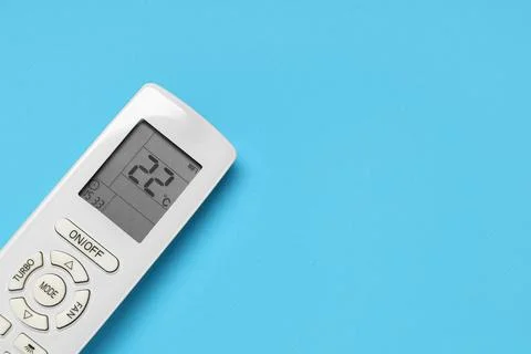 Air conditioner remote control on blue background Stock Photos