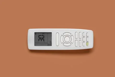 Air conditioner remote control on brown background Stock Photos