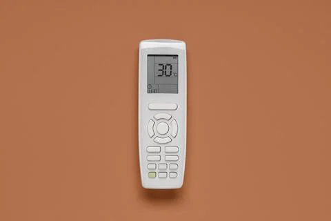 Air conditioner remote control on brown background Stock Photos
