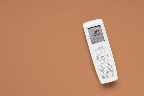 Air conditioner remote control on brown background Stock Photos