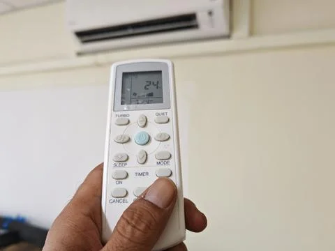Air Conditioner Remote Control Set to Comfort and Energy-Saving Modes Stock Photos
