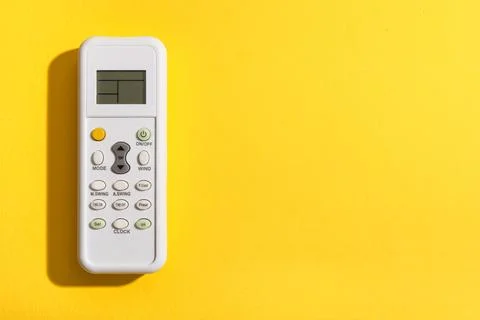 Air conditioner remote controller on yellow background Stock Photos