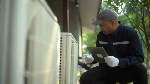 Air conditioner service outdoor checking fix repair with tablet. Air conditioner 库存影片 269187853