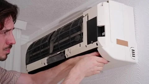 Air conditioner technician performing maintenance and repair Stock-Footage 338008544