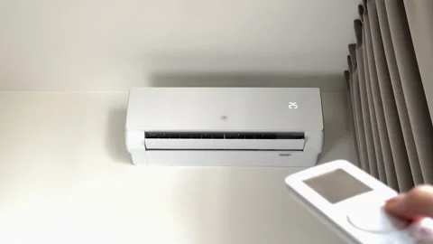 Air conditioner turned on with remote control to increase indoor room tempe.. Stock-Footage 346156992