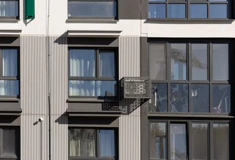 Air conditioner unit and security camera mounted on a modern facade. Contem.. Stock Photos