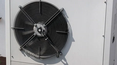 Air conditioner in white box at midday in summer, fan is spinning 動画素材 156912315