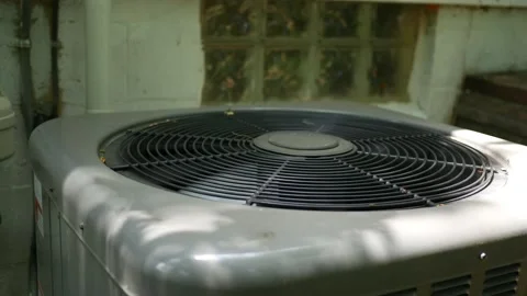 A air conditioner working hard on warm summer afternoon near residential ranch h Stock Footage 134568371