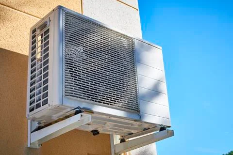 Air conditioning and heating compressor installed on the facade of a house Stock Photos