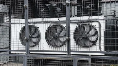 Air conditioning and ventilation system. Three large rotating fans behind bar Stock Footage 204148447