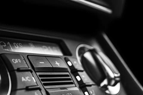 Air conditioning button inside a car. Climate control AC unit in the new ca.. Photos