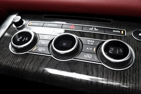 Air conditioning button inside a car. Climate control AC unit in the new ca.. Photos