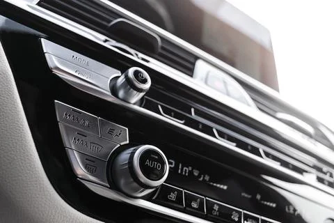 Air conditioning button inside a car. Climate control AC unit in the new ca.. Photos