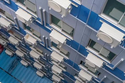 Air conditioning compressor system assembled on window of building Stock Photos
