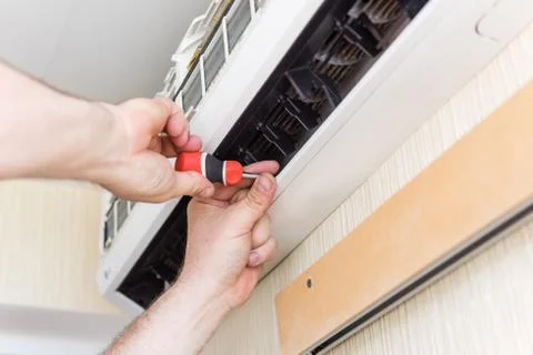 Air conditioning fix with screwdriver Stock Photos