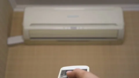 Air conditioning in the house to adjust the temperature in the room. A woman Video stock 132704839
