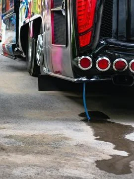 Air conditioning system drain pipe of bus drains wastewater onto road. Wate.. Stock Photos