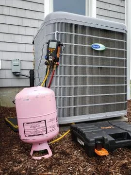 Air conditioning unit being charged with R410a refrigerant. Stock Photos