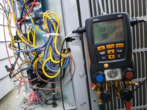 Air conditioning unit being charged with R410a refrigerant. Stock Photos