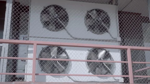 Air conditioning unit with four rotating fans on the wall of the building Stock Footage 64700227