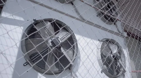 Air conditioning unit with four rotating fans on the wall of the building Stock Footage 64700348